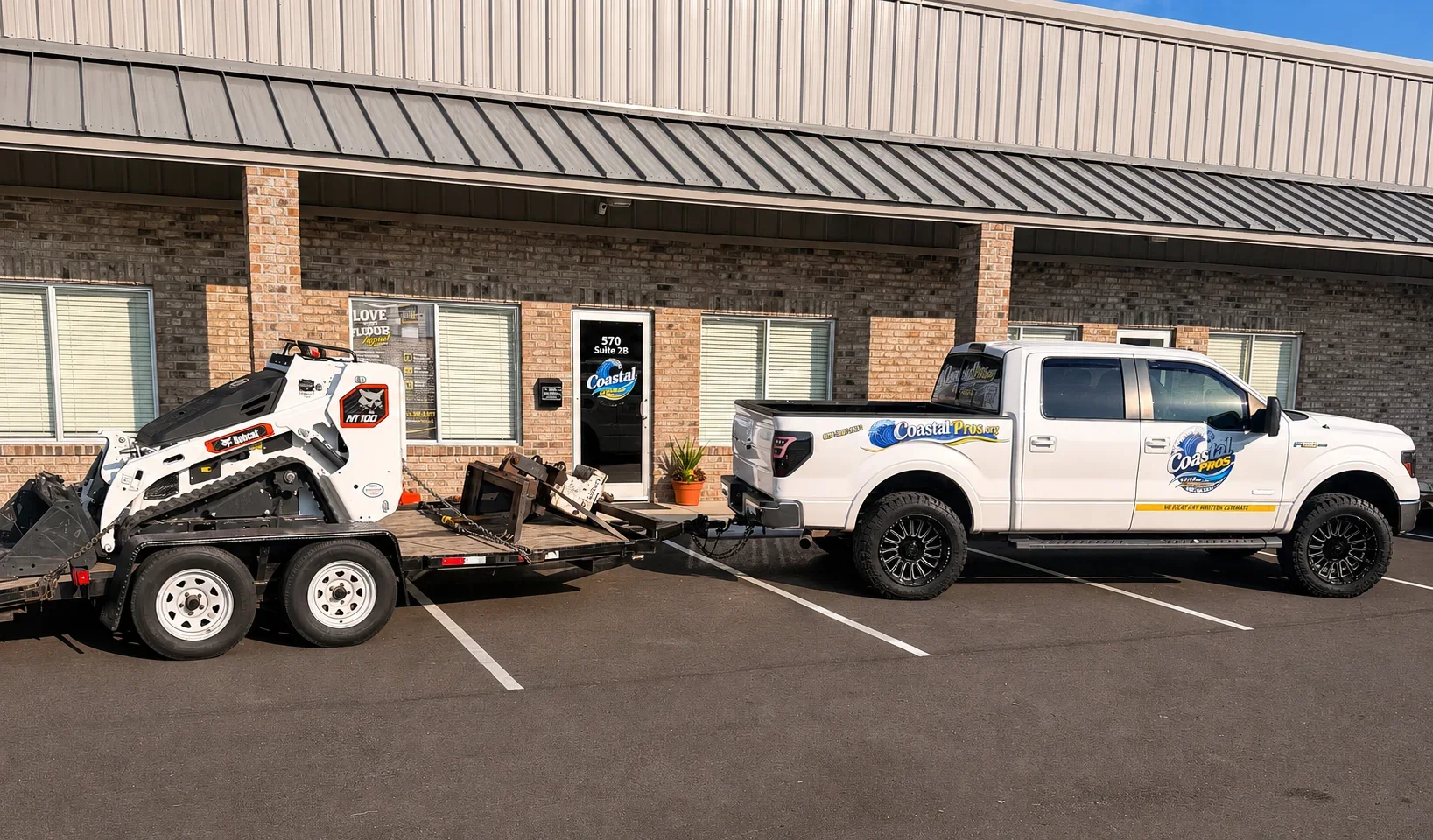 Skid steer loader and white pickup truck with debris removal equipment at commercial site