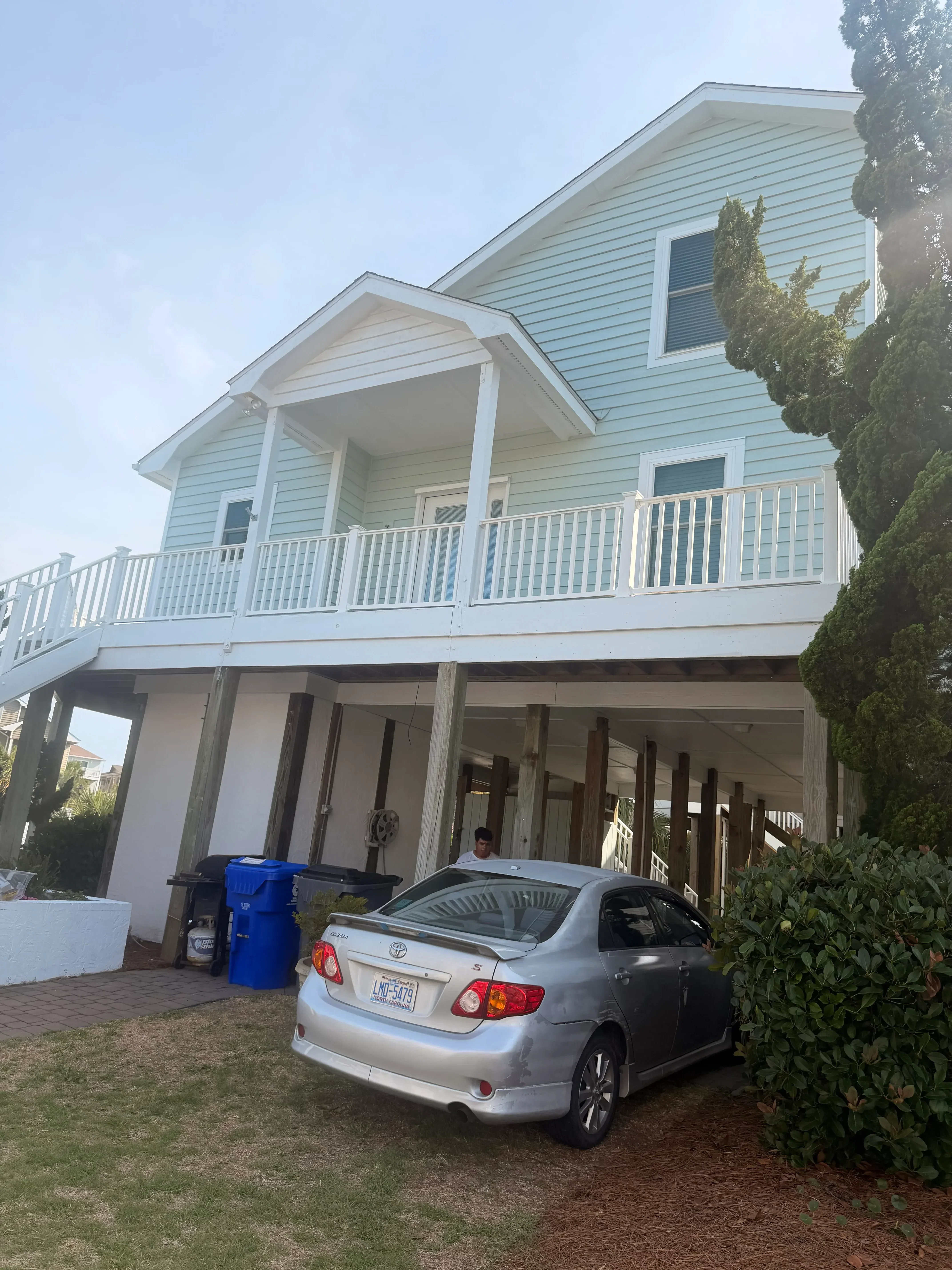 Multi-level composite deck with horizontal boards and integrated stairs, residential setting